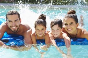 happy family swimming in a pool